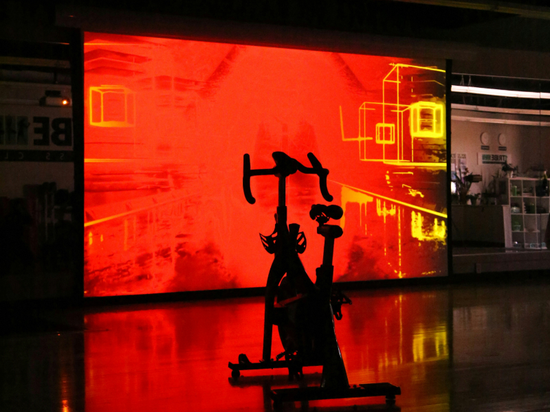 Fitness technology for beginners: A person exercising with smart home gym equipment like Peloton or Mirror.