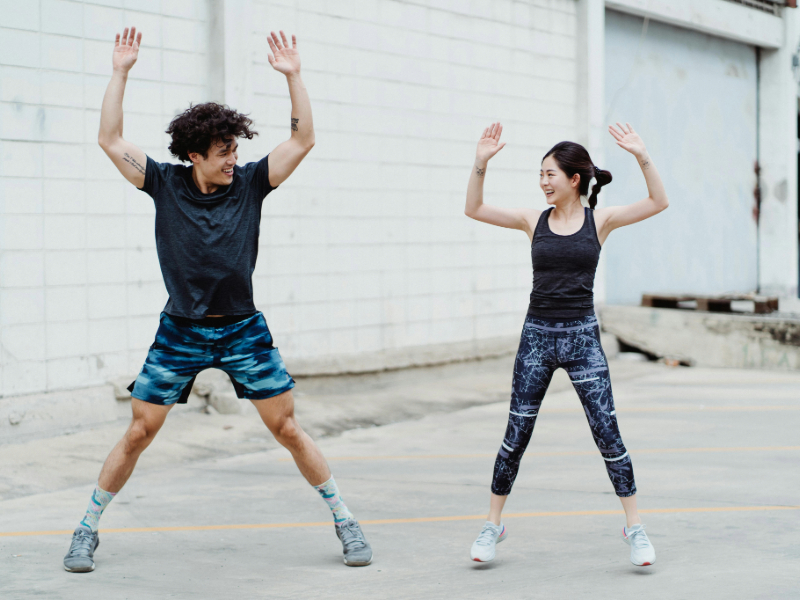 Woman doing beginner cardio workouts with jumping jacks